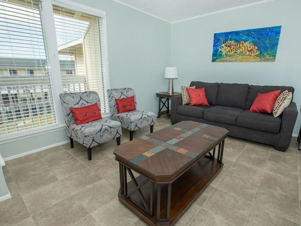 SPC tile-look flooring in a furnished apartment sitting room