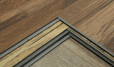 Stacked SPC flooring samples showing different rigid core and edge constructions