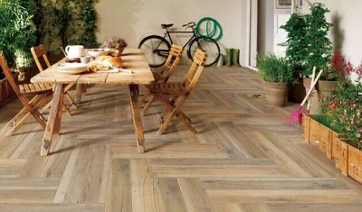 Herringbone wood-look flooring installed in an outdoor living setting